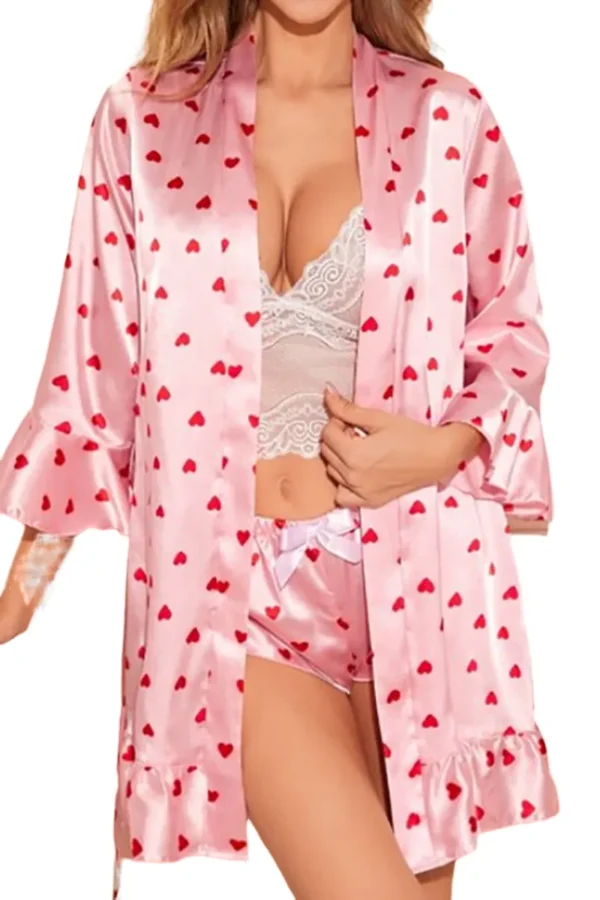 A model wearing a pink satin heart print loungewear set from the private label sexy loungewear collection.