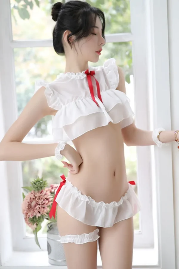Woman wearing classic white B2B sexy loungewear plus with red ribbon details and ruffles.