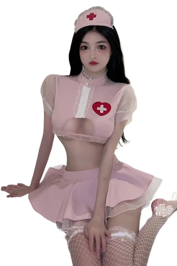 B2B nurse uniform women in a pink crop top and flared skirt with heart-shaped cross detail.