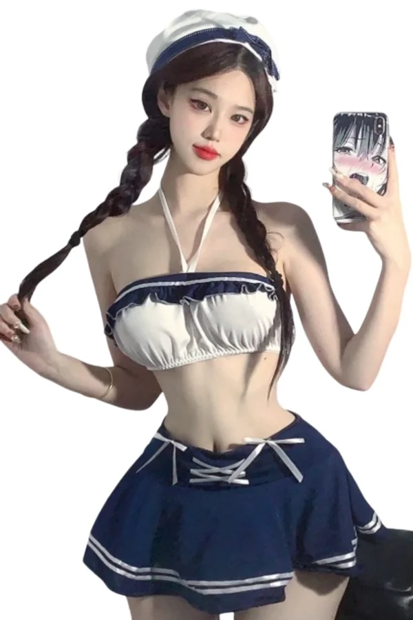 A model wearing a custom full body naughty school lingerie set with a sailor-inspired top and skirt.