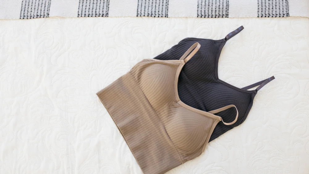 Diverse Product Offerings in Lingerie Manufacturer’s Production Capacity - Supreme Lingerie Two seamless bras in neutral tones, highlighting a lingerie manufacturer’s production capacity in producing diverse and inclusive designs.